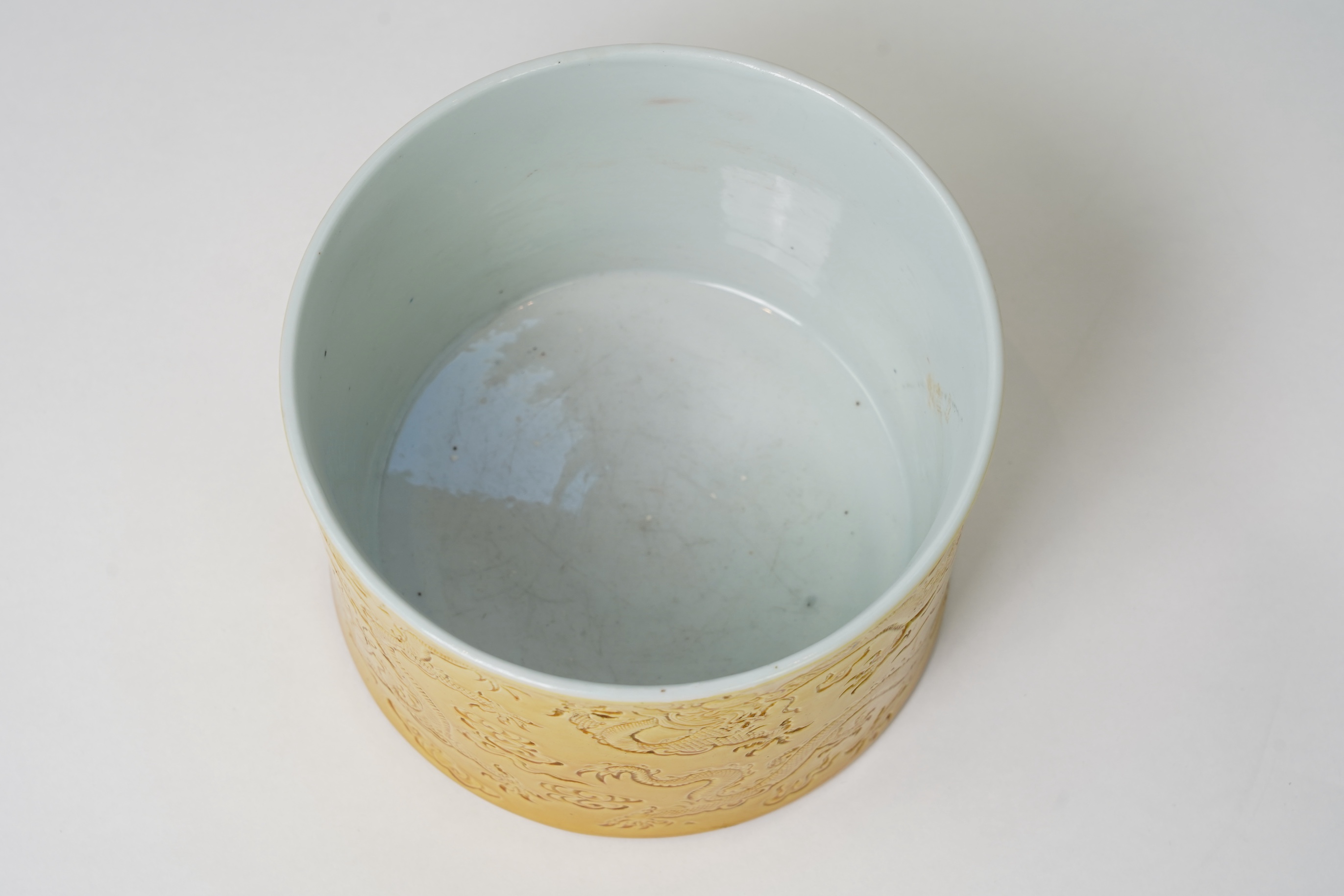 A Chinese yellow glazed 'dragon' brush pot, possibly Republic period